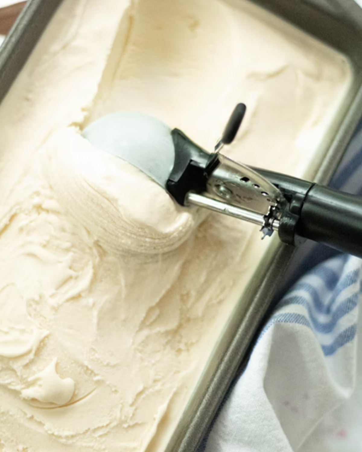 Scooping smooth homemade ice cream, highlighting improved aeration and creamy texture from Polysorbate 80.