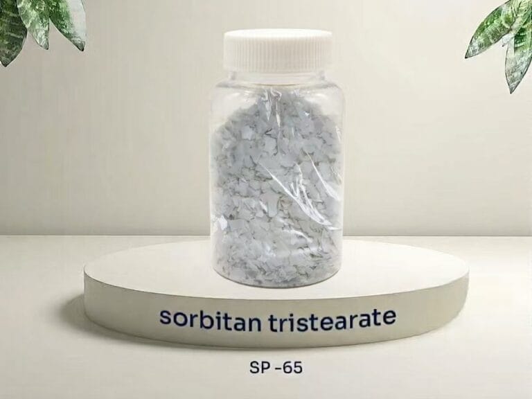 A transparent sample bottle filled with light cream-colored flakes of sorbitan tristearate (SP-65), placed on a white circular podium with text 'sorbitan tristearate SP-65'